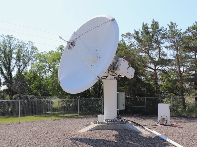 The Calian 4m QV band antenna tracks a satellite pass using high-speed slewing and precision Cassegrain optics.JPG